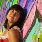 Woman with dark hair in front of painting